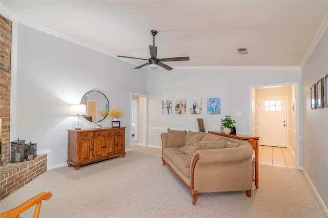 living area with light carpet, visible vents, a ceiling fan, baseboards, and ornamental molding