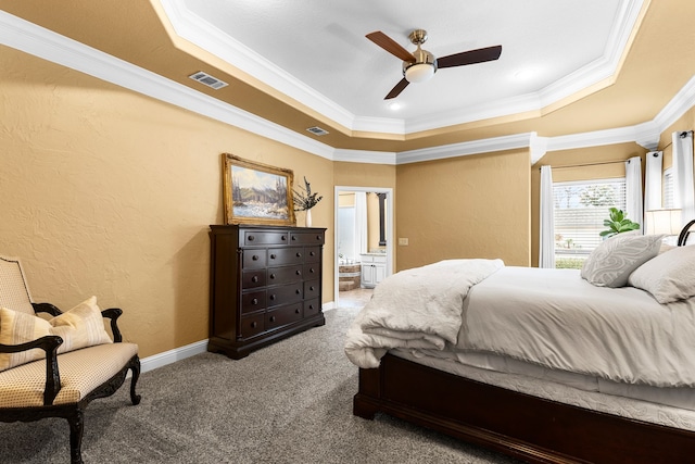 bedroom with carpet floors, visible vents, a tray ceiling, and a textured wall