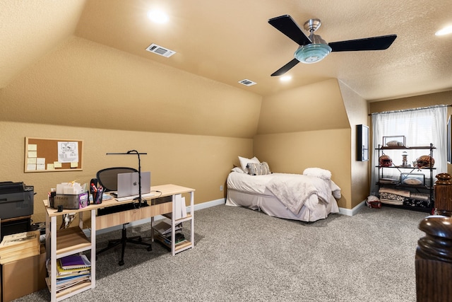 carpeted bedroom with visible vents, vaulted ceiling, and a textured ceiling