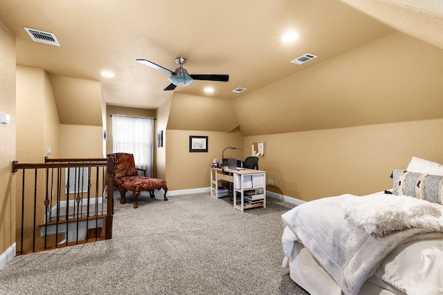 carpeted bedroom featuring lofted ceiling, baseboards, and visible vents