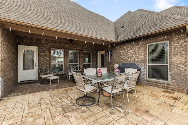 view of patio / terrace featuring outdoor dining area, a grill, and a ceiling fan