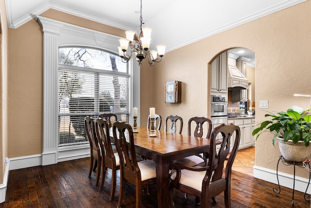 dining space featuring hardwood / wood-style floors, crown molding, and a textured wall