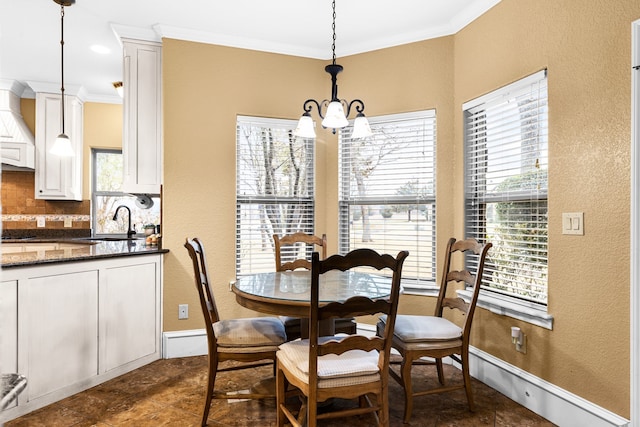 dining area with a chandelier, a textured wall, ornamental molding, and baseboards