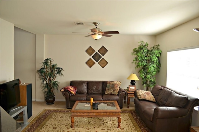 living room featuring baseboards, carpet, visible vents, and a ceiling fan