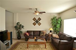 living area with ceiling fan