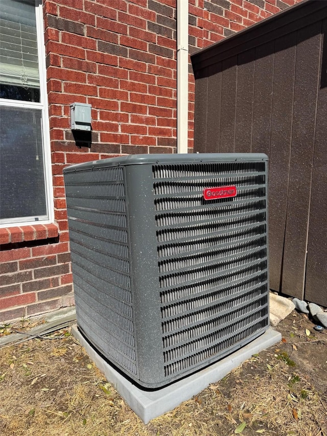 exterior details with central air condition unit and brick siding