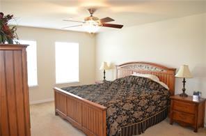 bedroom featuring a ceiling fan and light colored carpet