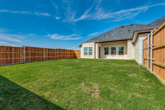 view of yard with a fenced backyard