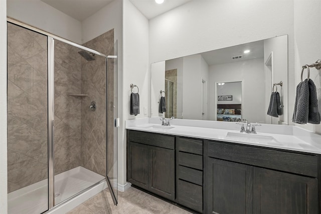 full bathroom featuring a sink, double vanity, a stall shower, and connected bathroom