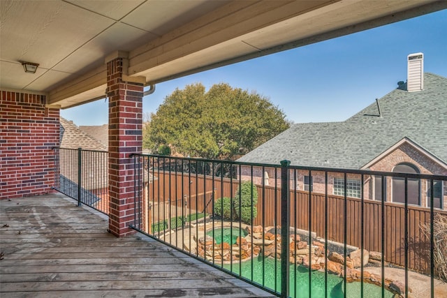 deck with an outdoor hot tub