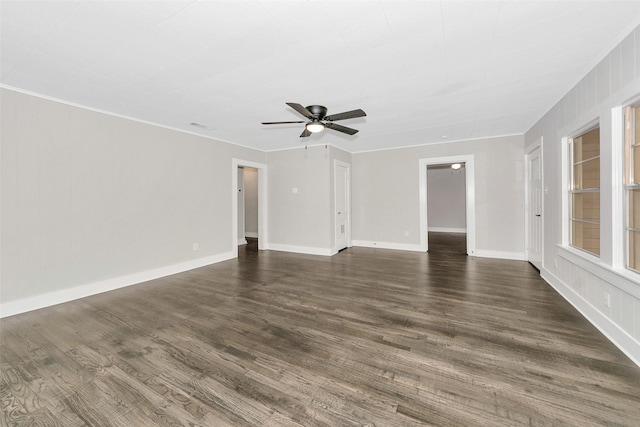 unfurnished living room with baseboards, a ceiling fan, and dark wood-style flooring