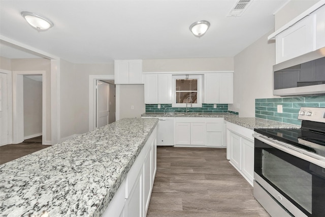 kitchen featuring appliances with stainless steel finishes, dark wood-style flooring, white cabinets, and light stone countertops