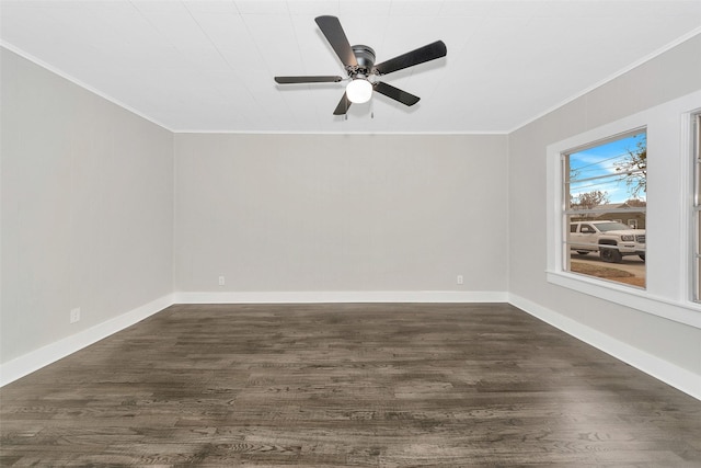 empty room with baseboards, ceiling fan, dark wood finished floors, and crown molding