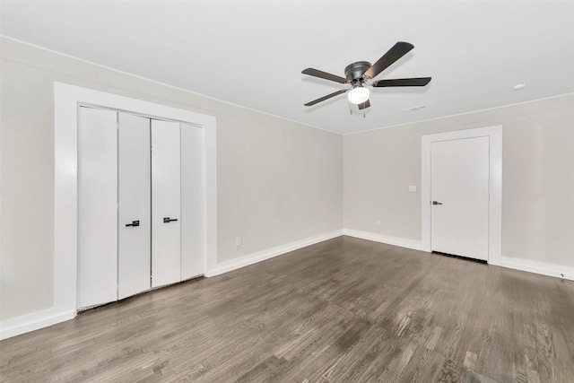 unfurnished bedroom featuring visible vents, ceiling fan, baseboards, and wood finished floors