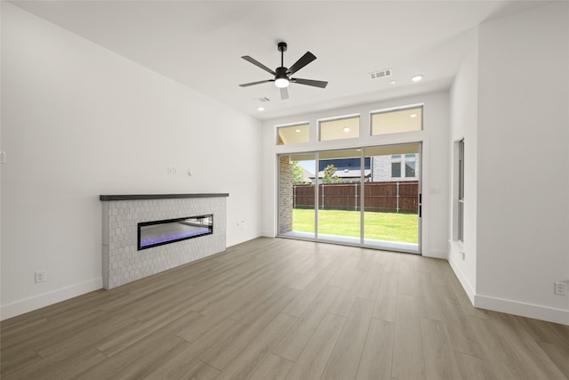 317 Willie Way, Burleson, TX 76028 - unfurnished living room with a glass covered fireplace, wood finished floors, ceiling fan, and baseboards
