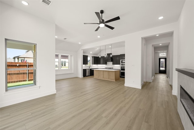 317 Willie Way, Burleson, TX 76028 - unfurnished living room featuring light wood finished floors, baseboards, recessed lighting, ceiling fan, and a fireplace