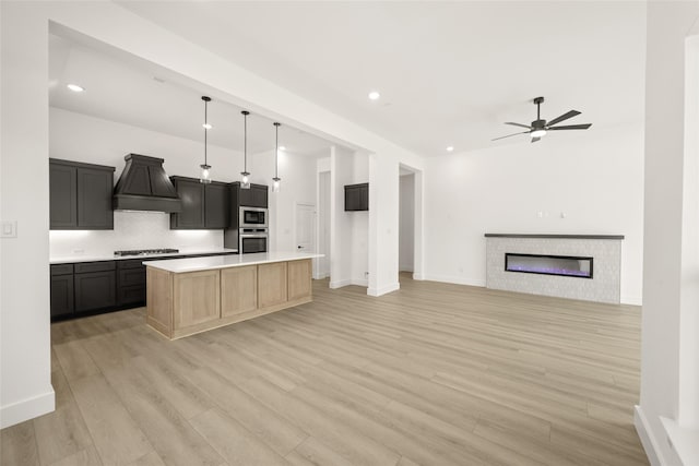 317 Willie Way, Burleson, TX 76028 - kitchen featuring appliances with stainless steel finishes, custom range hood, backsplash, a ceiling fan, and open floor plan