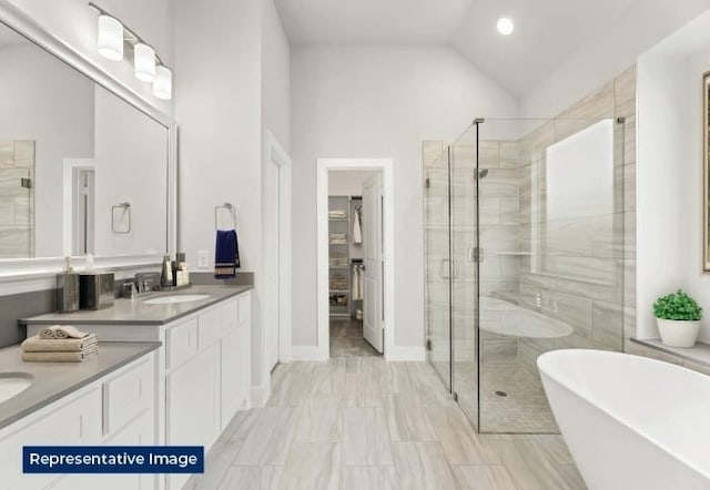 bathroom with vanity, lofted ceiling, a soaking tub, and a shower stall