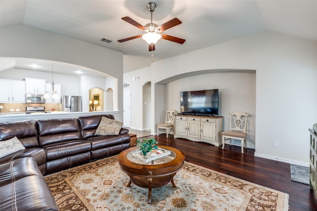 living room featuring lofted ceiling, visible vents, and dark wood finished floors