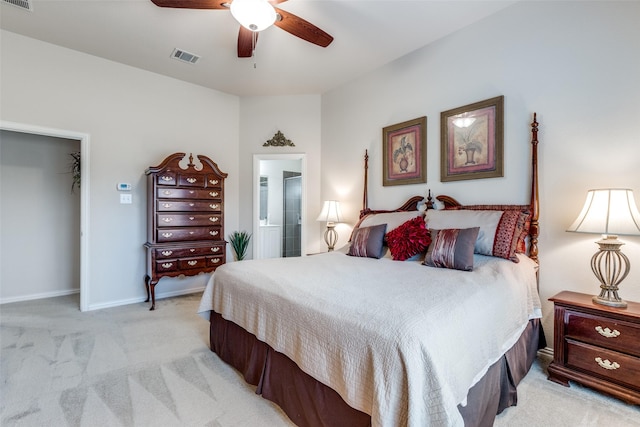 bedroom featuring a walk in closet, visible vents, light carpet, connected bathroom, and baseboards