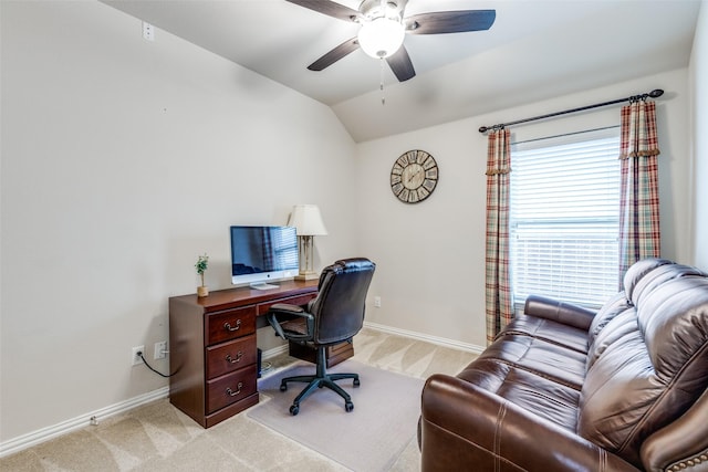 office area featuring lofted ceiling, ceiling fan, baseboards, and light colored carpet