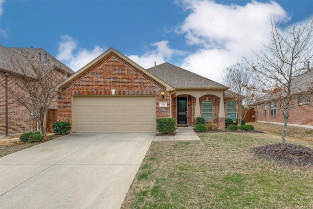 view of front of house featuring a garage, brick siding, driveway, roof with shingles, and a front yard