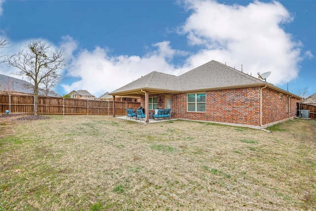 rear view of house with a patio area, central AC unit, a lawn, and brick siding