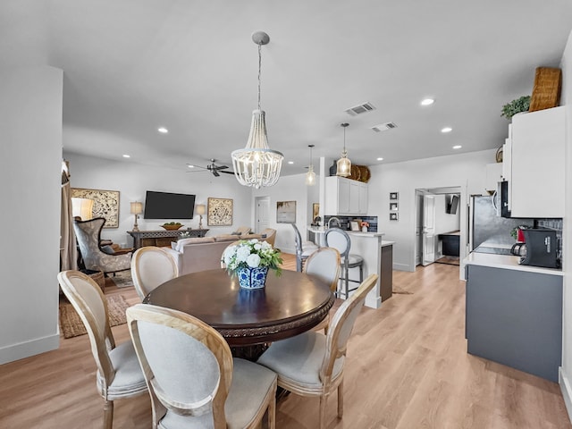 dining room with light wood-type flooring, visible vents, and recessed lighting