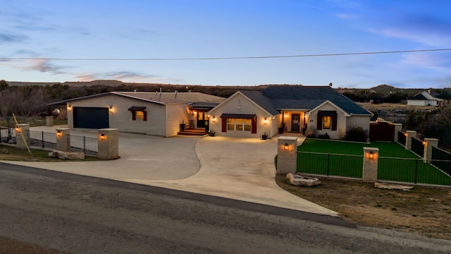 view of front of property with driveway, a fenced front yard, and a front yard