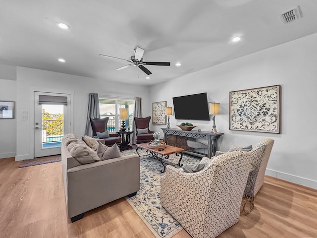 living area featuring a ceiling fan, wood finished floors, visible vents, and recessed lighting