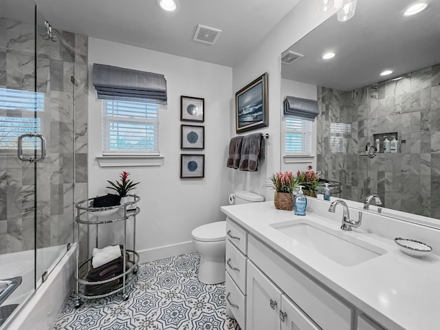 bathroom with visible vents, toilet, vanity, and baseboards