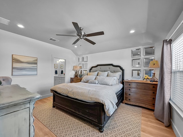 bedroom featuring lofted ceiling, recessed lighting, visible vents, and light wood-style floors