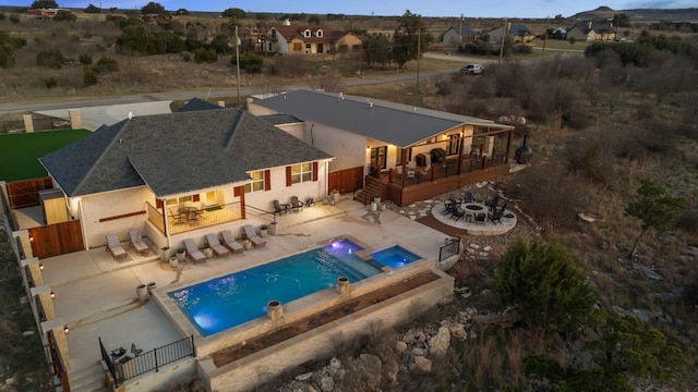 pool with a fire pit, a patio, a fenced backyard, an in ground hot tub, and a deck