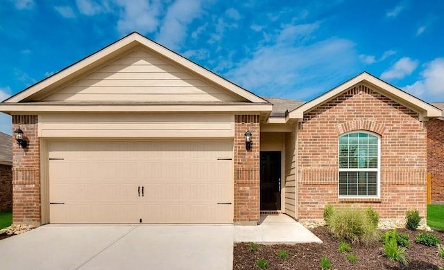 single story home featuring driveway, an attached garage, and brick siding