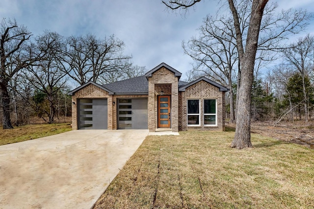 modern home featuring brick siding, a shingled roof, concrete driveway, a front yard, and a garage