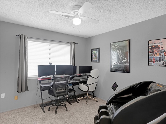 carpeted home office featuring a ceiling fan and a textured ceiling