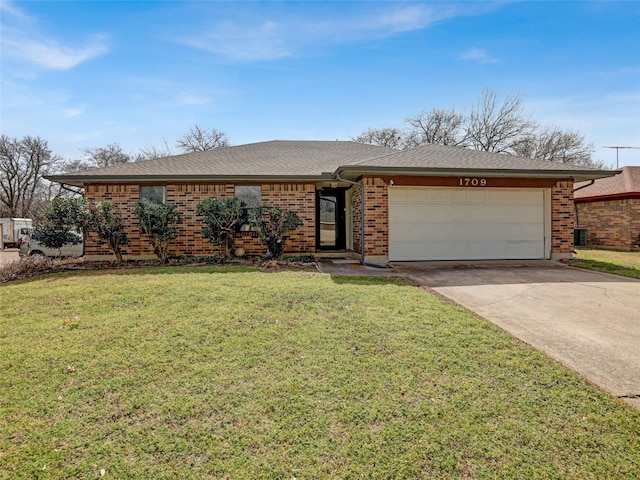 ranch-style home featuring an attached garage, brick siding, driveway, roof with shingles, and a front yard