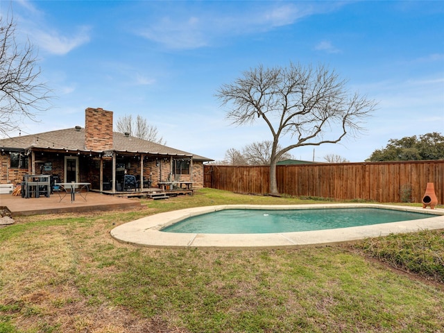 view of pool featuring a lawn, a patio area, a fenced backyard, and a fenced in pool