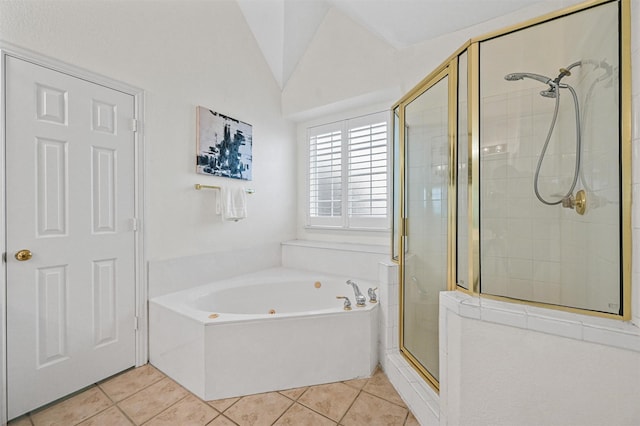 bathroom with lofted ceiling, a shower stall, a bath, and tile patterned floors