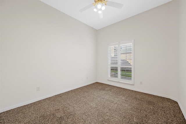 empty room with a ceiling fan, carpet, vaulted ceiling, and baseboards