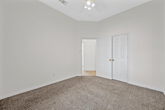 unfurnished bedroom featuring light carpet, baseboards, visible vents, and ceiling fan