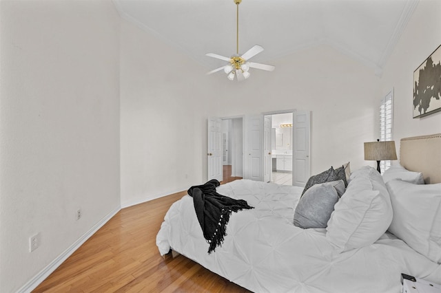 bedroom featuring crown molding, light wood finished floors, connected bathroom, ceiling fan, and baseboards