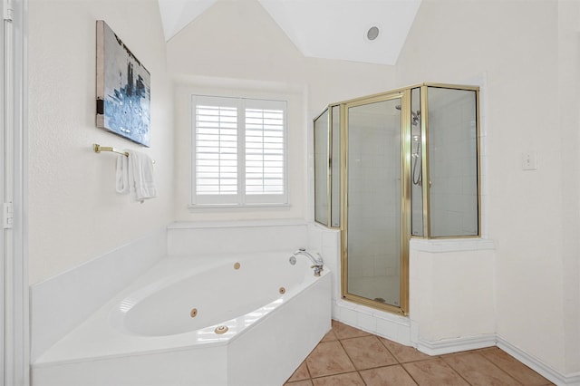 bathroom with lofted ceiling, a jetted tub, a shower stall, and tile patterned floors