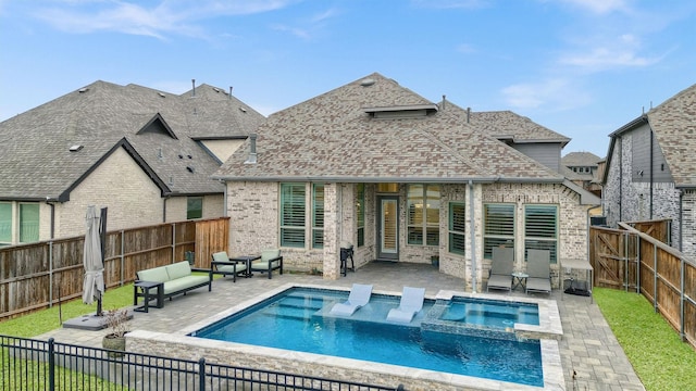 rear view of house featuring a patio, a fenced backyard, brick siding, and a shingled roof