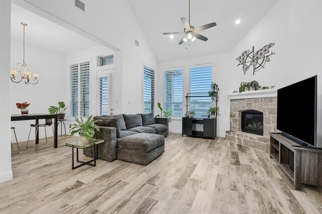 782 Corner Post Path, Celina, TX 75009 - living room with a ceiling fan, light wood-style flooring, a stone fireplace, baseboards, and high vaulted ceiling