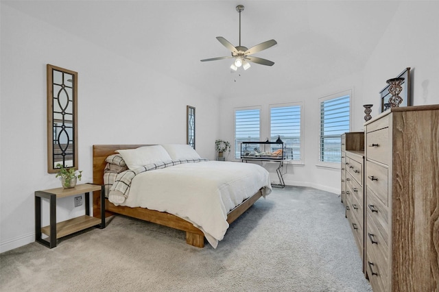 bedroom with baseboards, light carpet, ceiling fan, and vaulted ceiling