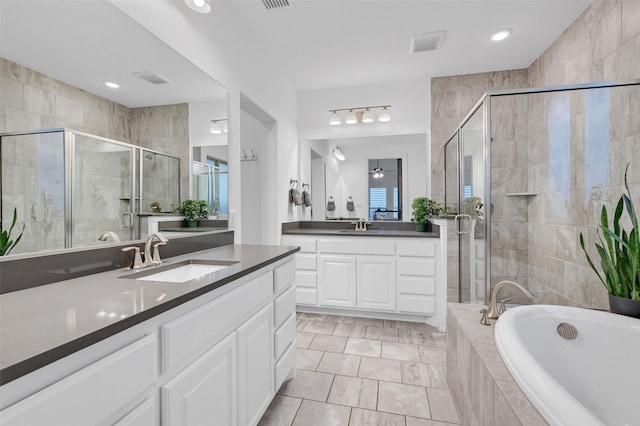 bathroom with a sink, a bath, and a shower stall