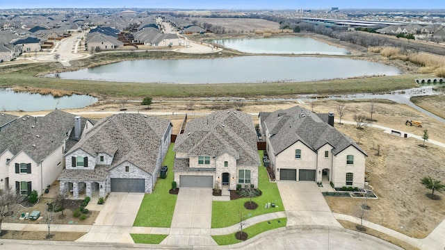 birds eye view of property with a water view and a residential view