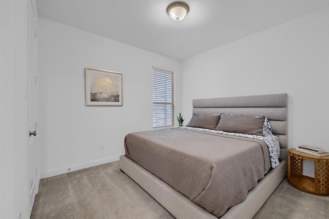 bedroom featuring carpet flooring and baseboards