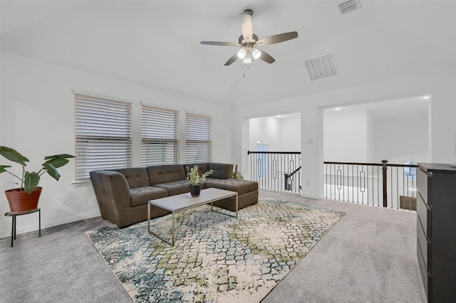 carpeted living area with visible vents, baseboards, and a ceiling fan